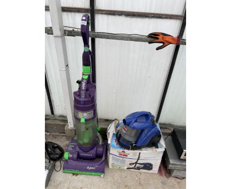 A DYSON DC04 VACUUM CLEANER AND A BISSELL COMPACT VACUUM CLEANER 