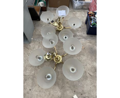 A PAIR OF HEAVY BRASS FIVE BRANCH CEILING LIGHT FITTINGS WITH GLASS SHADES 