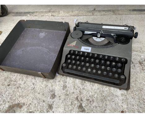 A VINTAGE HERME BABY TYPEWRITER WITH CARRY CASE 