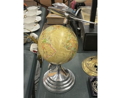 AN ART DECO CHROME JET ON A GLOBE PEDESTAL 