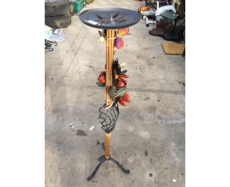 A TALL METAL AND CANE CANDLESTICK 