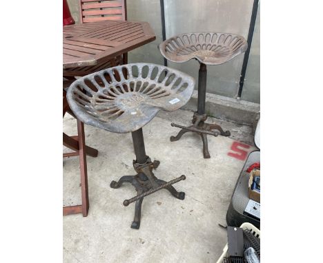 A PAIR OF VINTAGE INDUSTRIAL STYLE STOOLS WITH IMPLEMENT SEATS 