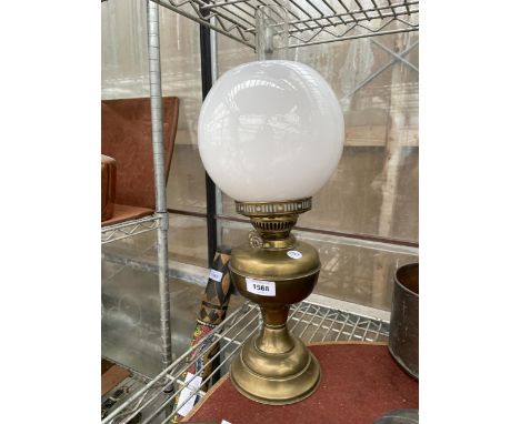 A VINTAGE BRASS OIL LAMP WITH WHITE GLASS SHADE AND CLEAR GLASS FUNNEL 