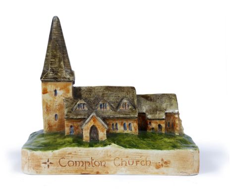 AN EARLY 20TH CENTURY ARTS AND CRAFTS POTTERY MODEL OF COMPTON CHURCH decorated in coloured enamels and with inscription to t