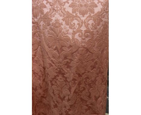 A PAIR OF PINK GROUND DAMASK TYPE CURTAINS with scrolling acanthus leaf decoration, each curtain with a drop of approximately