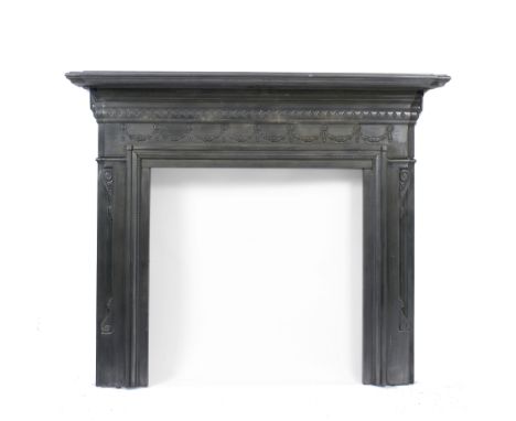 A VICTORIAN POLISHED CAST IRON FIRE SURROUND in the neo classical style with shaped mantelpiece, the frieze decorated with ac