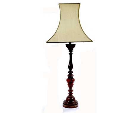 AN ANTIQUE FRUITWOOD CANDLE STAND of knopped, turned and baluster form, now converted to a table lamp 56cm