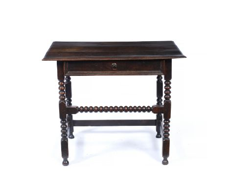 A LATE 17TH CENTURY OAK SIDE TABLE, the top with a moulded edge above frieze drawer and bobbin turned legs and stretcher, 88c