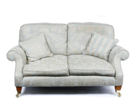 A GOLD BROCADE UPHOLSTERED TWO SEATER SOFA with scrolling arms and on square tapering legs terminating in brass feet and cast