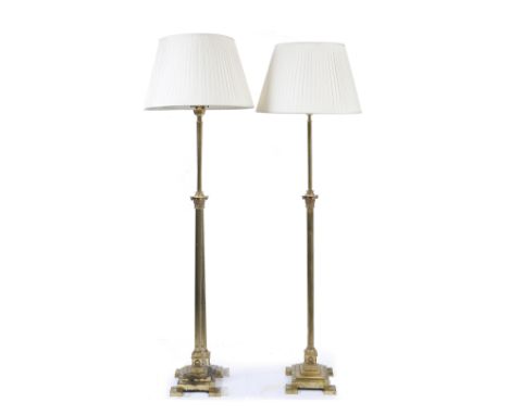 A PAIR OF BRASS LAMP STANDARDS of reeded Corinthian column form and on stepped plinth bases with outset square feet, 180cm hi