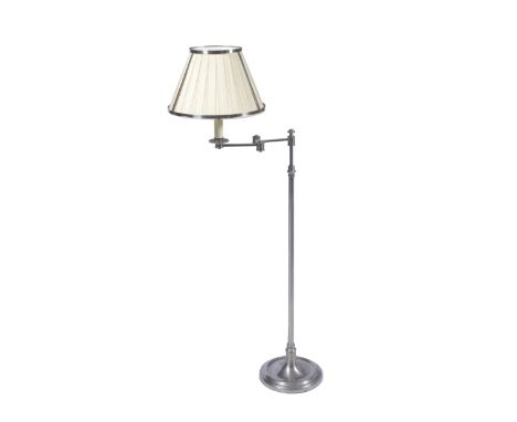 A LATE 20TH CENTURY CHROME PLATED FLOOR STANDING READING LAMP with hinged adjustable lamp and circular spreading base 130cm h