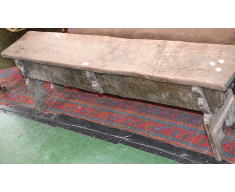 A rustic oak bench. 48cm high x 152cm long.