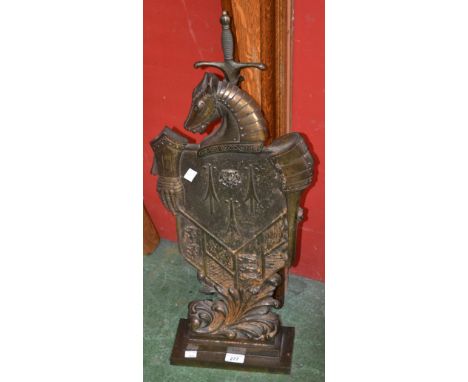 A cast iron knight's shield and sword firescreen, reg. no. 780686, no.333 with poker and brush