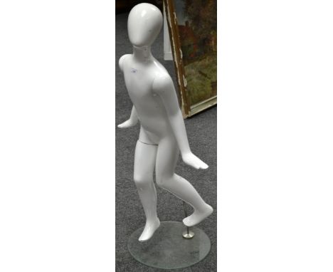 A shop window display mannequin, Child Running, white body, glass disc stand, 126cm high