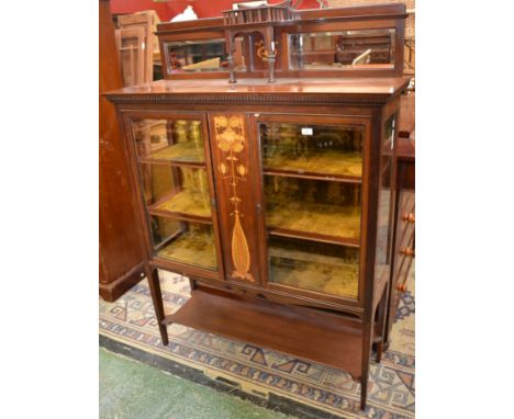 An Art Nouveau mahogany and marquetry salon cabinet, shaped cresting above a superstructure centred by a projecting three-qua