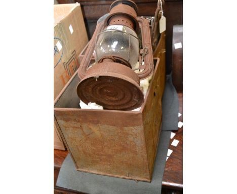 A paraffin lamp; a Tilley lamp with glass shade; others, similar