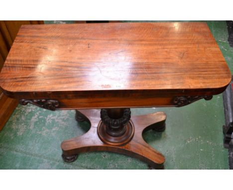 A George IV rosewood rounded rectangular card table, circular red baize playing surface, tapering octagonal column decorated 