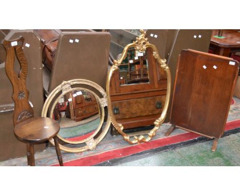 An oak spinning stool; a mahogany firescreen/table; a gilt framed Rococo wall mirror; another circular (4) 