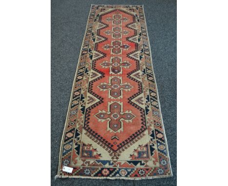 An Oriental carpet runner 9'6" x 2'8"