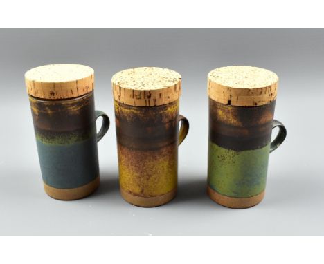 ROBIN WELCH (1936-2019); three tall stoneware mugs with original cork covers, impressed marks, height 15.5cm (3). (D) Provena