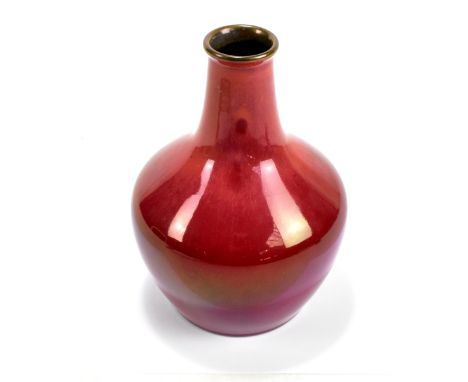 ROYAL LANCASTRIAN; a glazed bulbous vase with cylindrical neck, decorated with oxblood glaze with gold lustre rim, impressed 