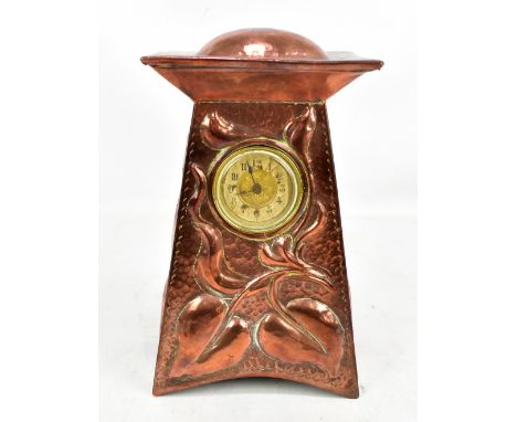 IN THE MANNER OF JOHN PEARSON; an Arts and Crafts copper mantle clock, with planished and relief decoration, height 23cm (rep