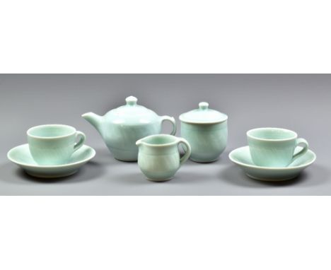 DEREK EMMS (1929-2004); a porcelain tea set covered in celadon glaze, comprising teapot, milk jug, sugar bowl and cover and p