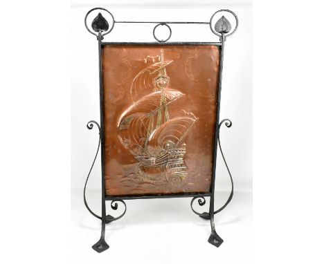 An Arts and Crafts fire screen with copper central panel decorated with a galleon, raised on outswept supports, height 80cm.