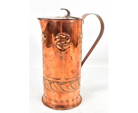 A Scottish Arts and Crafts copper water jug repoussé decorated with stylised roundels and motifs, unmarked, height 31cm.Addit