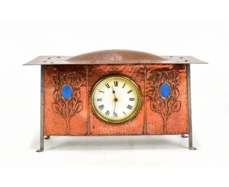 ATTRIBUTED TO GEORGE WALTON; an Arts and Crafts copper mantle clock, the main body with planished decoration with two panels 