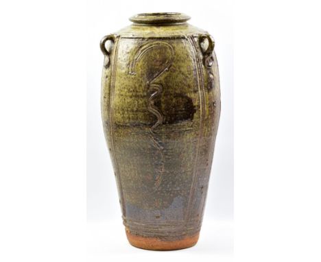 JIM MALONE (born 1946); a tall stoneware lugged vase covered in mottled green ash glaze with incised decoration, impressed JM