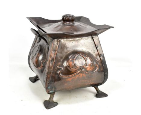 An Arts and Crafts copper log bucket of square form, relief decorated with&nbsp;central floral sprays, raised on four out-swe