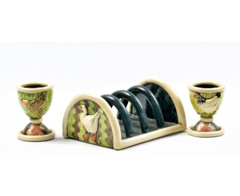 ANNA LAMBERT (born 1957); an earthenware toast rack decorated with ducks and a pair of egg cups decorated with chickens, inci
