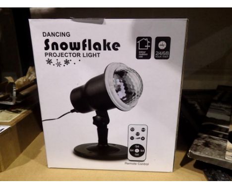 New old stock Dancing Snowflake Projector Light for outdoor and indoor use with remote, boxed, working at lotting. Not availa