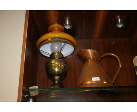 A LARGE COPPER JUG TOGETHER WITH A CONVERTED OIL LAMP WITH YELLOW GLASS SHADE 