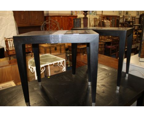 A PAIR OF MODERN BLACK AND GLASS LAMP TABLES