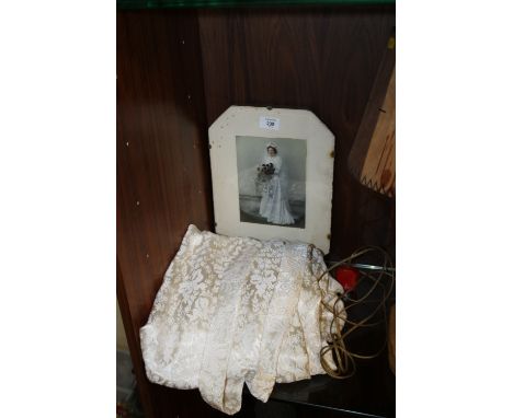 AN EARLY TO MID 20TH CENTURY VINTAGE WEDDING DRESS, complete with original photograph of the bride in period frame, the dress