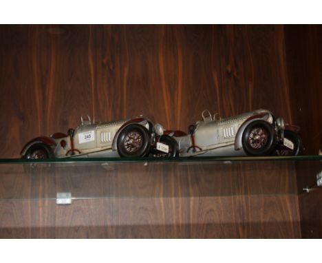 A PAIR OF MODERN REPRODUCTION TIN PLATE VINTAGE CARS