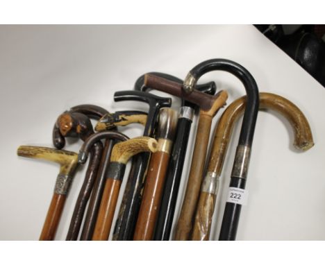 A COLLECTION OF VINTAGE WALKING STICKS TO INCLUDE HALLMARKED SILVER EXAMPLES 