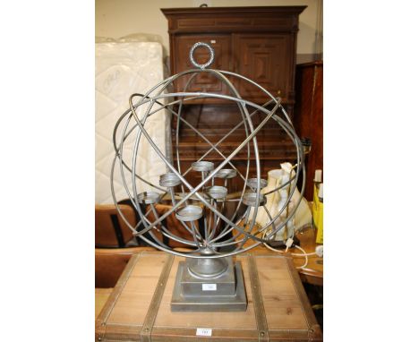 A MODERN METAL GLOBE CANDLE STAND