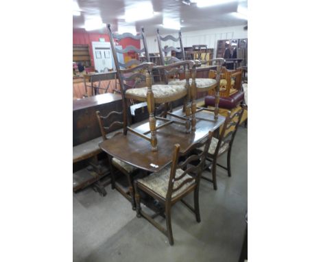 An Ercol Old Colonial dark elm dresser, refectory table and six ladderback chairs 