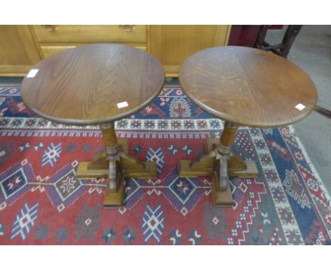 A pair of oak circular lamp tables 