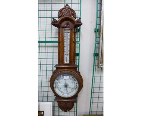 A Victorian carved oak aneroid barometer, glass cracked 