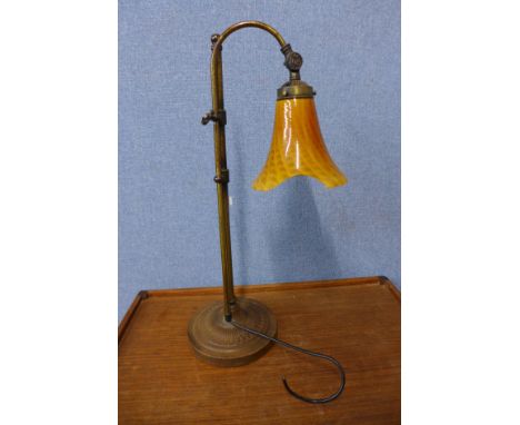 A brass adjustable desk lamp 