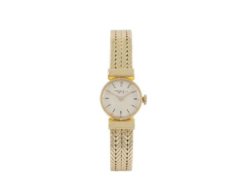 A Lady's 18 carat gold wristwatch by Patek Philippe, the circular silvered dial with black baton indexes to a flat woven fanc
