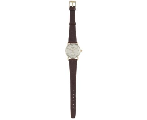 A Gentleman's wristwatch by Patek Philippe, circa 1946, 18 carat gold, automatic, silvered dial with point and Arabic numeral