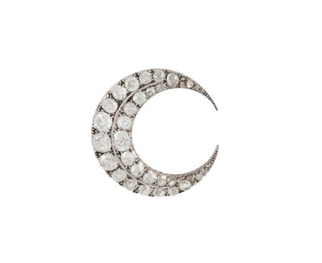 An early 20th Century diamond crescent moon brooch, composed of a double row of graduated old cushion-cut and rose-cut diamon