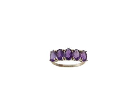 An Amethyst ring and earrhoops, the ring composed of a row of oval mixed-cut amethyst to front, mounted in 10 carat gold, rin