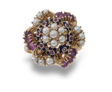 A cultured pearl and ruby dress ring, the flower head design composed of a cluster of cultured pearls to a surround of circul