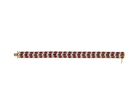 A ruby and diamond bracelet, composed of an alternating row of oval mixed-cut rubies between round brilliant-cut diamonds wit